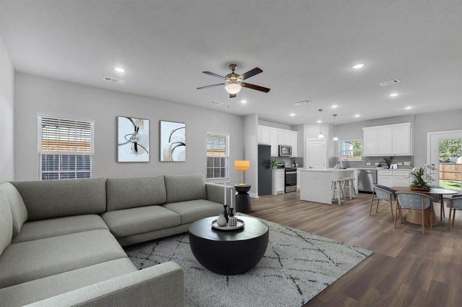 Living room with ceiling fan and hardwood / wood-style flooring