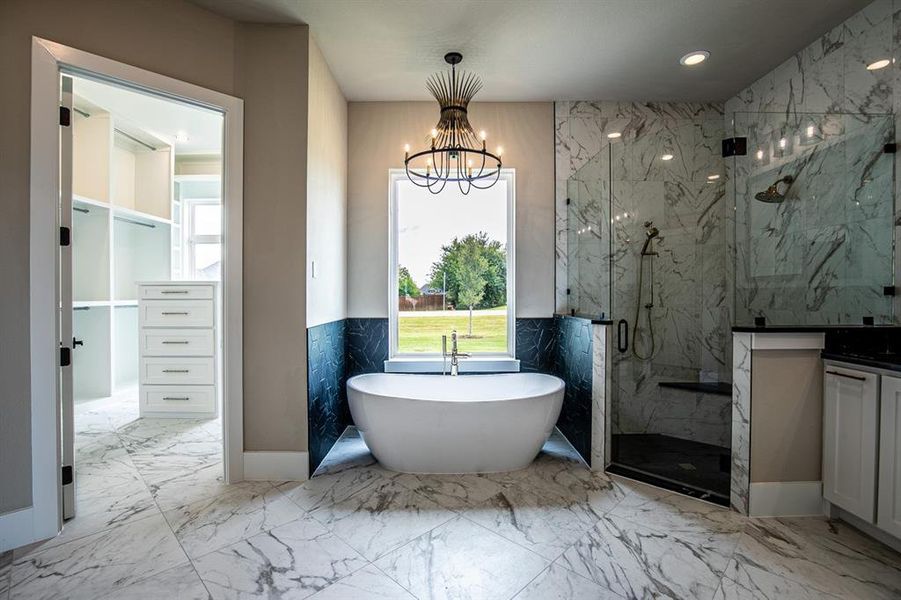 Bathroom featuring plus walk in shower, vanity, tile patterned flooring, and a chandelier