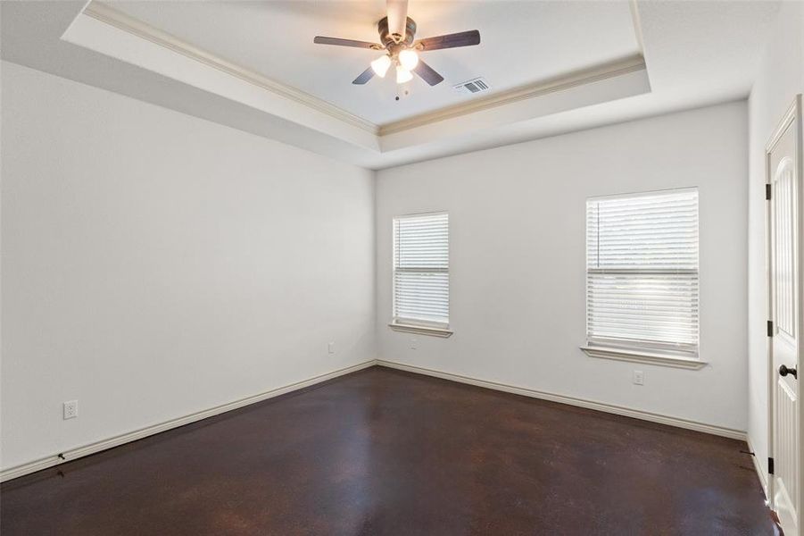 Spare room featuring ceiling fan, crown molding, and a tray ceiling