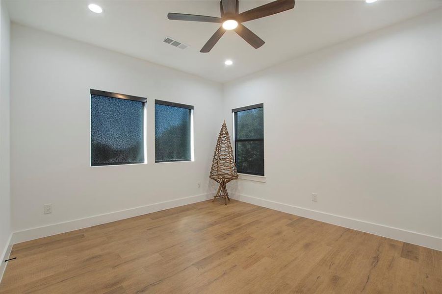 Unfurnished room with light hardwood / wood-style flooring and ceiling fan