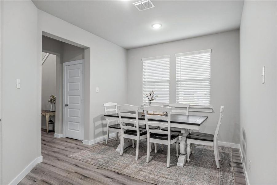 Dining area with light hardwood / wood-style flooring