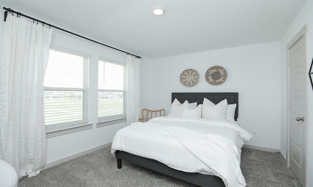 Bedroom upstairs has plenty of natural light.