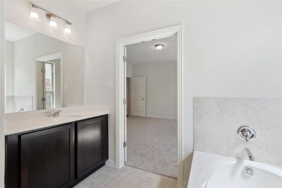 Bathroom featuring vanity and tile patterned flooring