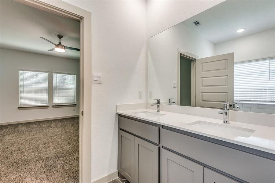 Primary bathroom features tile floors, dual sinks, and walk-in closet.