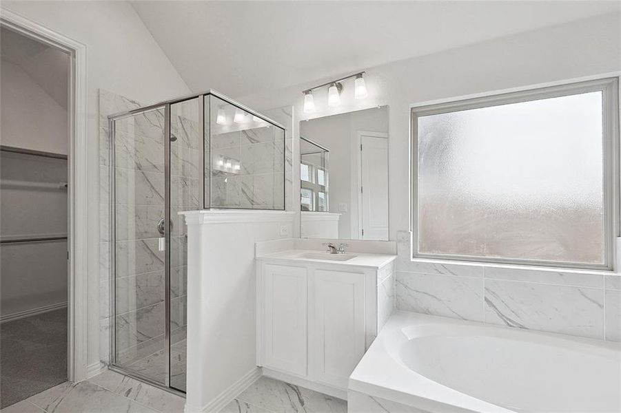 Bathroom featuring vanity, plus walk in shower, tile patterned flooring, and lofted ceiling