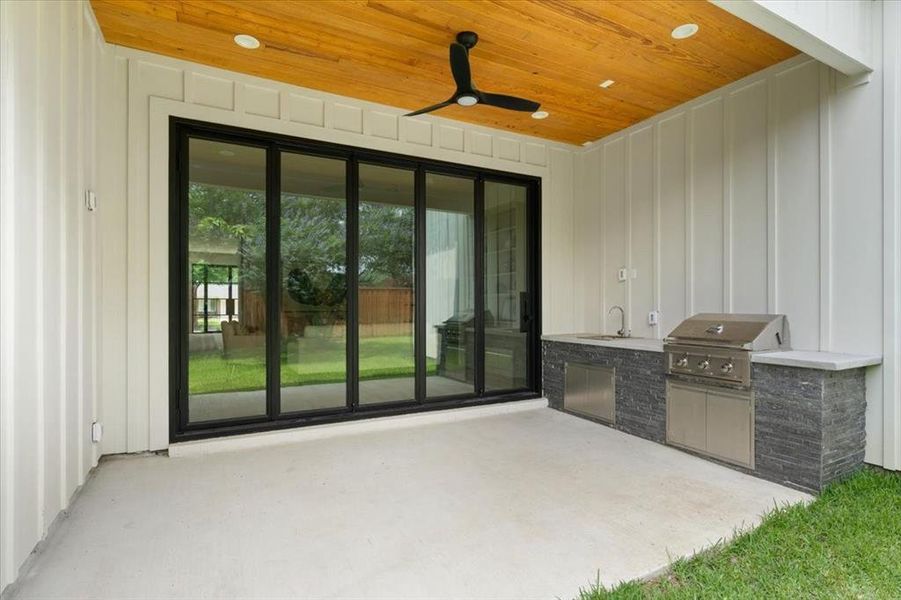 View of patio / terrace with area for grilling, an outdoor kitchen, sink, and ceiling fan