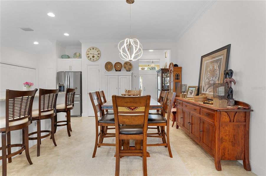 LED Modern Chandelier is the Centerpiece of this Dining Room.