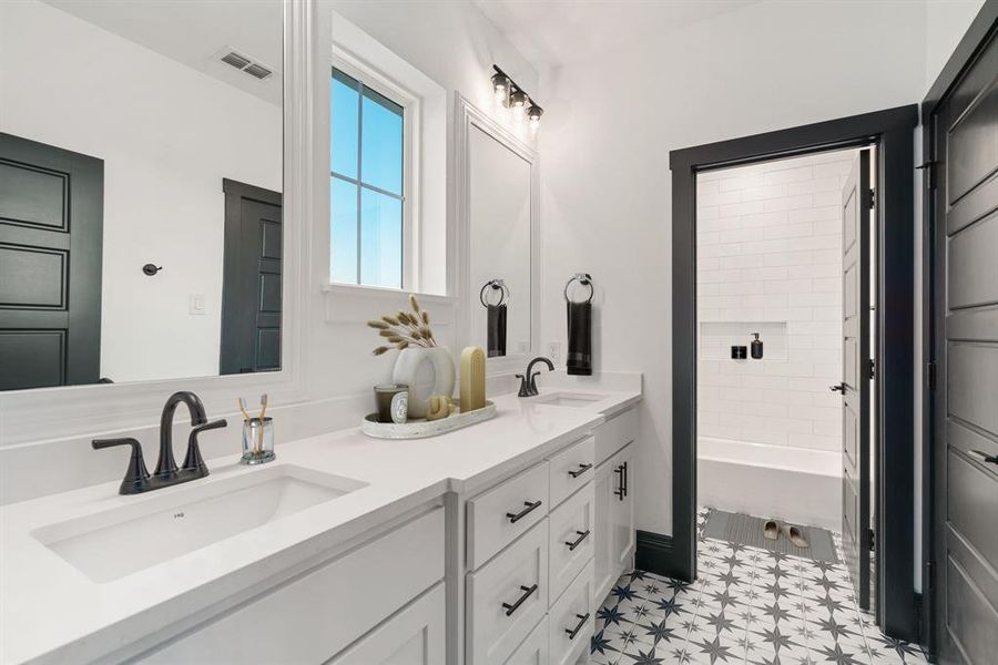 Plenty of sinks upstairs with this spacious vanity and separate tub-shower area. Love the window and the floors! *Virtually staged.