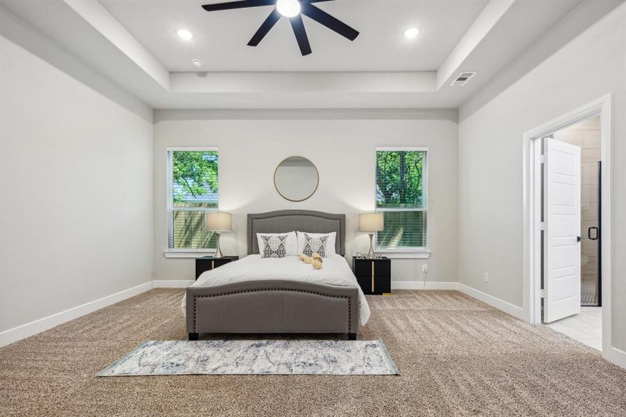 Bedroom with multiple windows, carpet floors, and ceiling fan