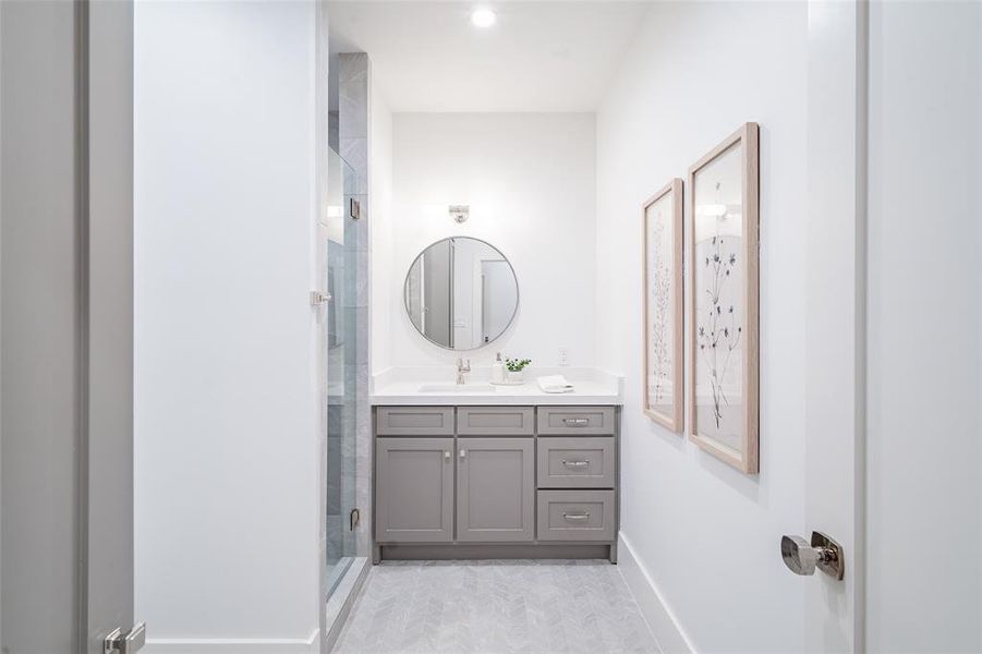 Bathroom with vanity and a shower with shower door