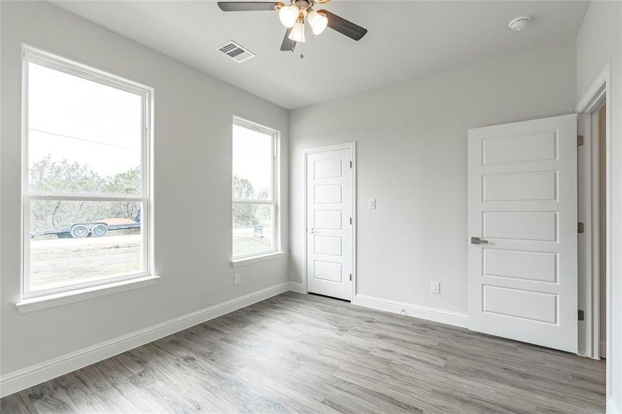 Unfurnished room featuring ceiling fan and light hardwood / wood-style floors