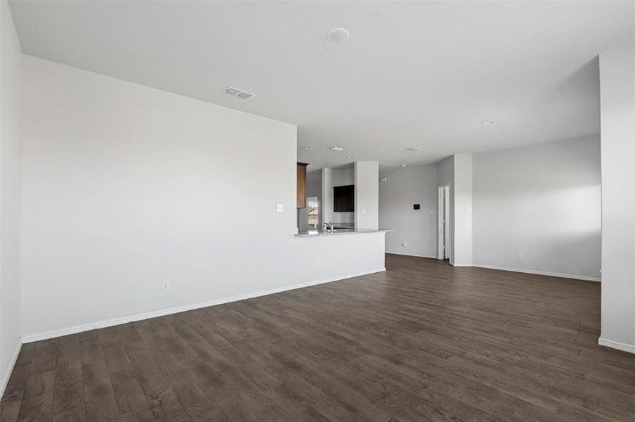 Unfurnished living room with dark hardwood / wood-style flooring