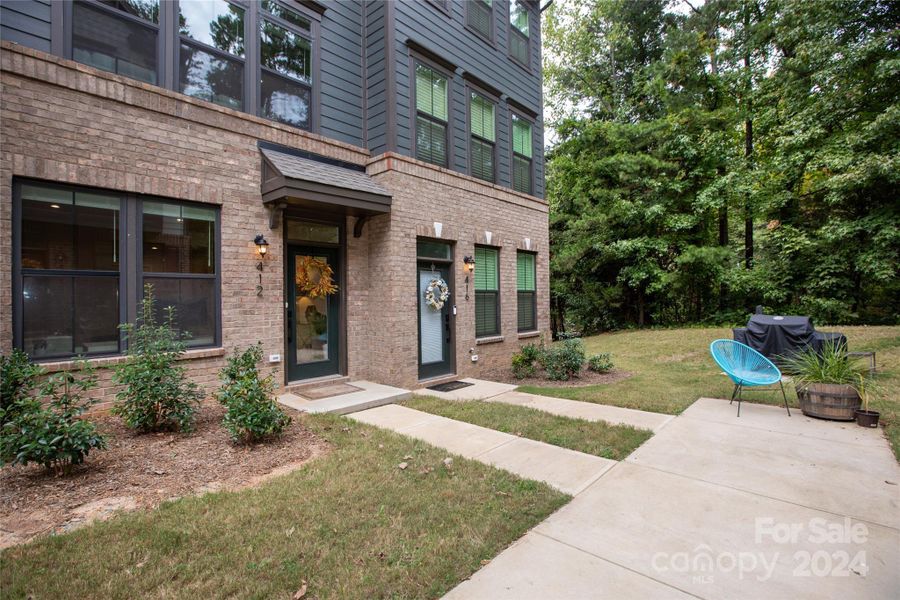 Corner-adjacent unit offers privacy and wooded views.