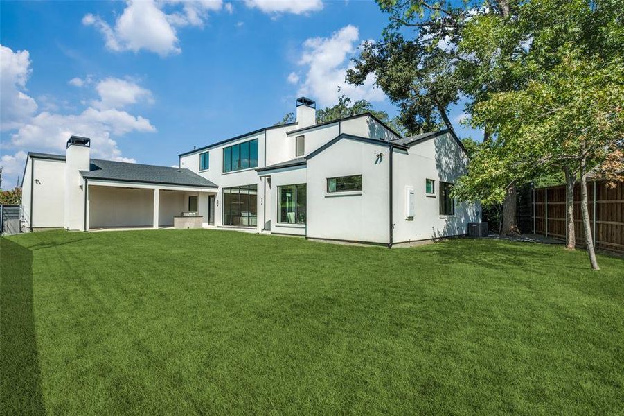 Back of house with a yard and cooling unit