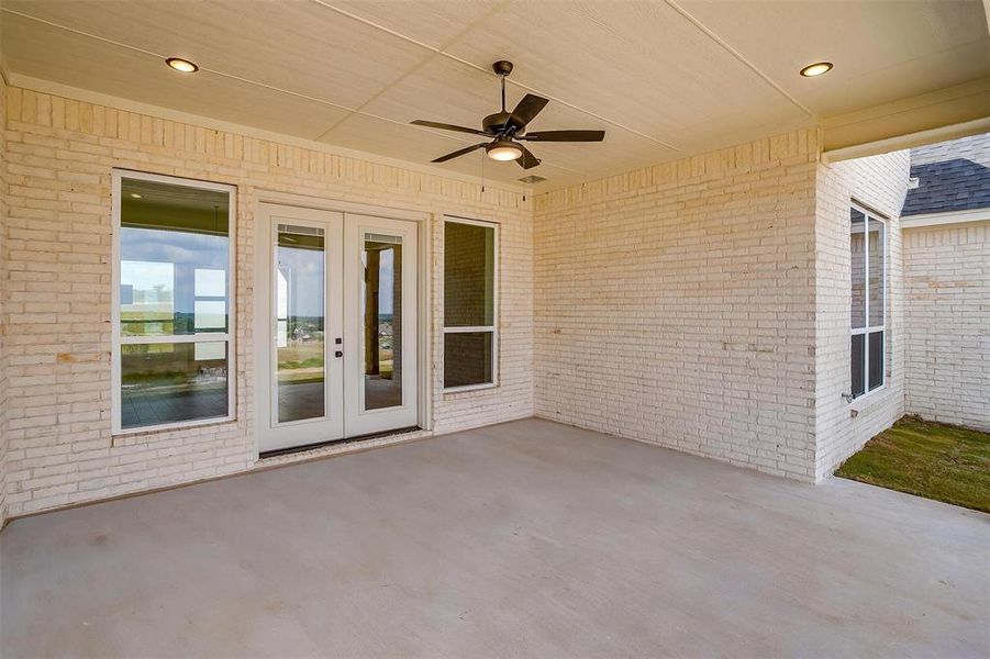 View of patio featuring french doors and ceiling fan