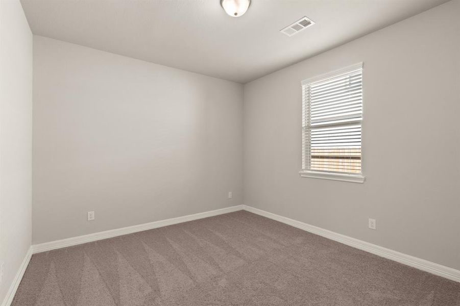 Your secondary bedroom features plush carpet, fresh paint, closet, and a large window that lets in plenty of natural lighting.