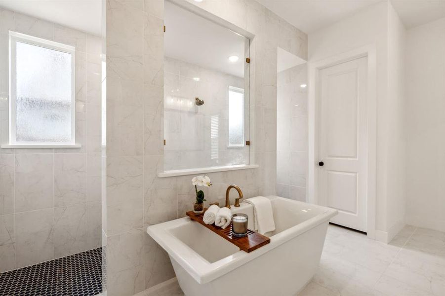 Main Bathroom featuring tile patterned flooring, tile walls, and a bath