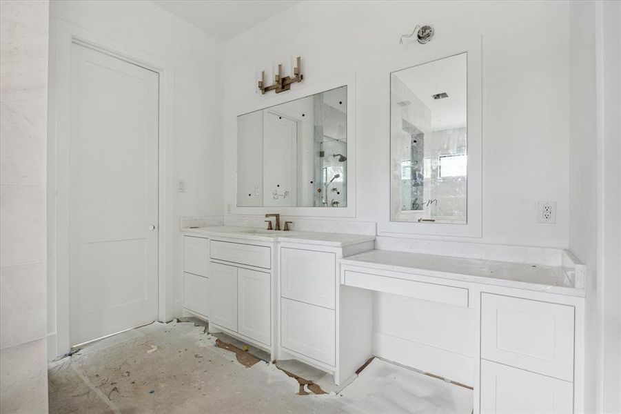 Primary bath vanity area. One of two closet access doors to the left of the picture. Photo as of 9/3/2024