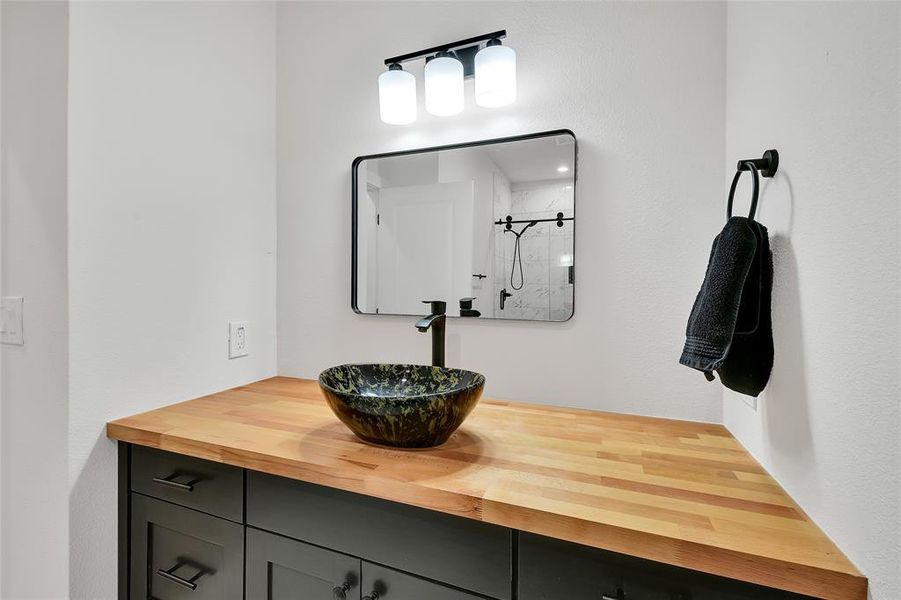 Bathroom with vanity and a shower