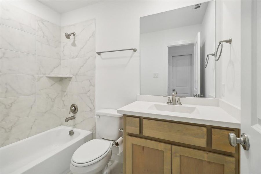 4th Full bathroom featuring tiled shower / bath, oversized vanity, and toilet