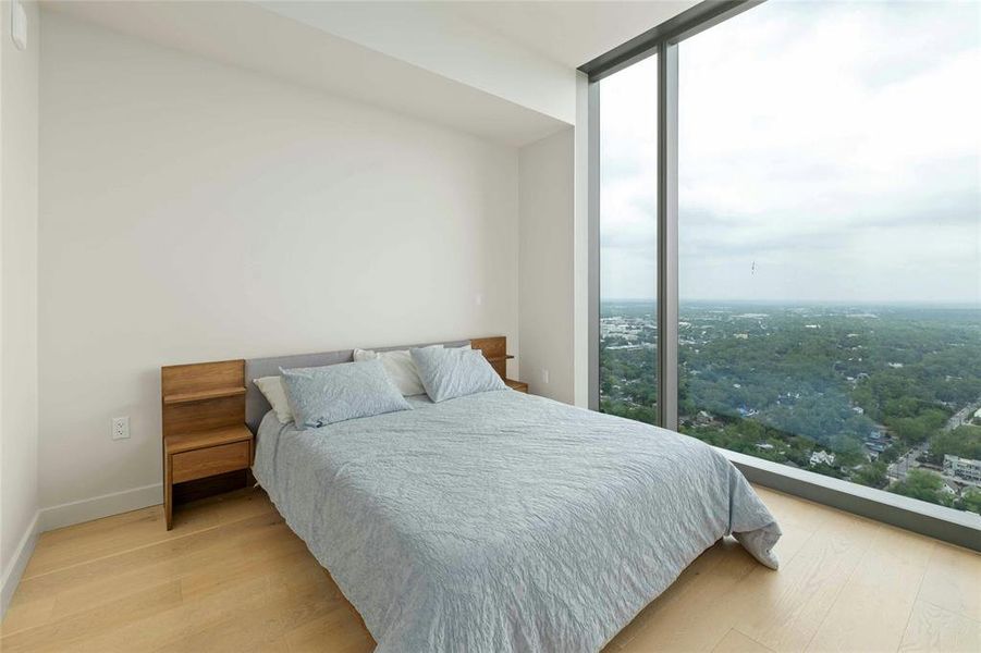 Bedroom with floor to ceiling windows with views of downtown Austin and Lady Bird Lake