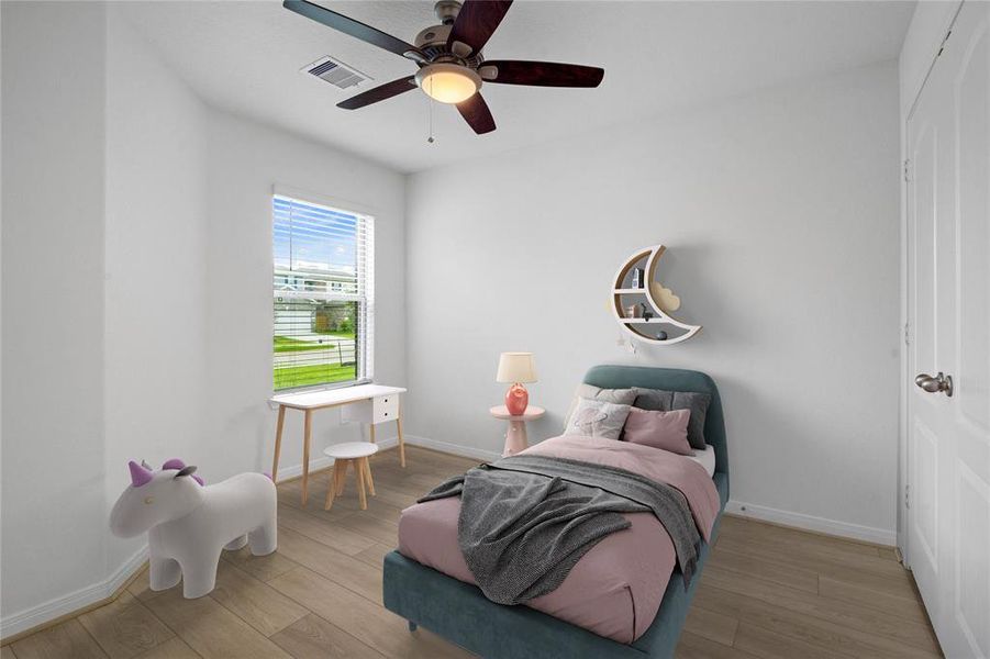 Secondary bedroom features vinyl plank flooring, ceiling fan, custom paint and a large window.