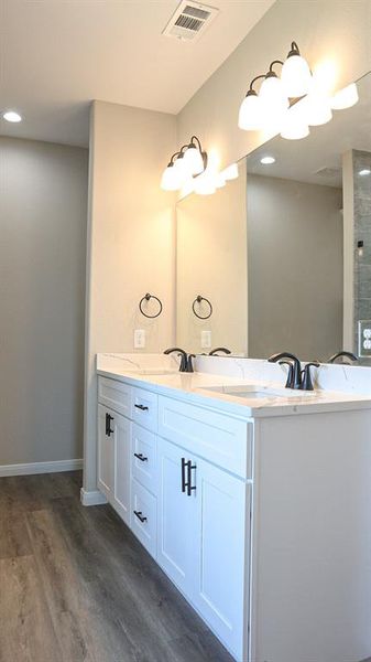 Bathroom featuring vanity and hardwood / wood-style floors