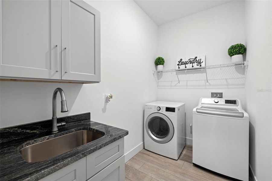 Laundry Room is Spacious with Full Size Washer/Dryer Hookup and a Laundry Sink with Granite Countertops & Cabinet Storage