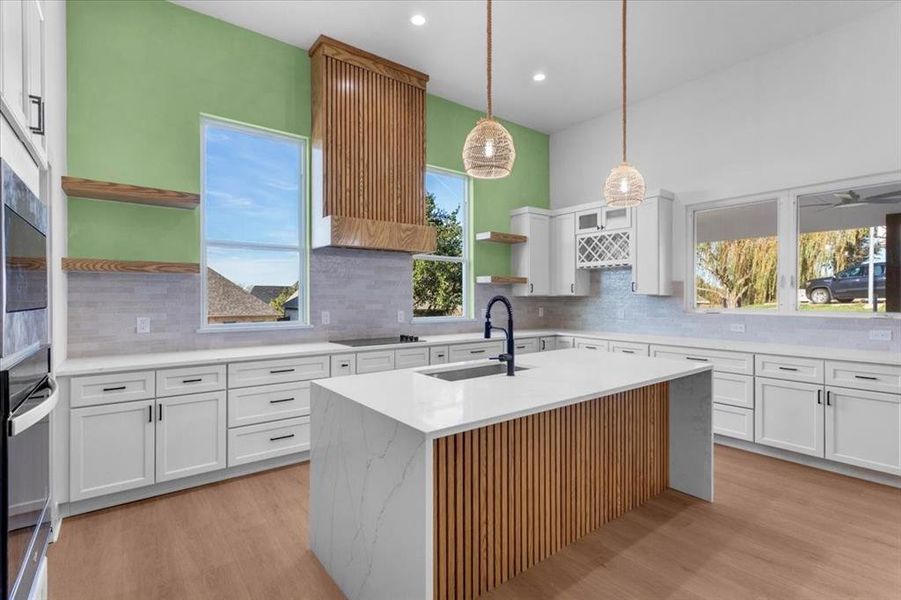 Kitchen featuring white cabinetry, sink, and a healthy amount of sunlight