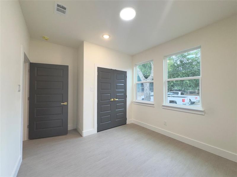 Unfurnished bedroom with a closet and light hardwood / wood-style flooring