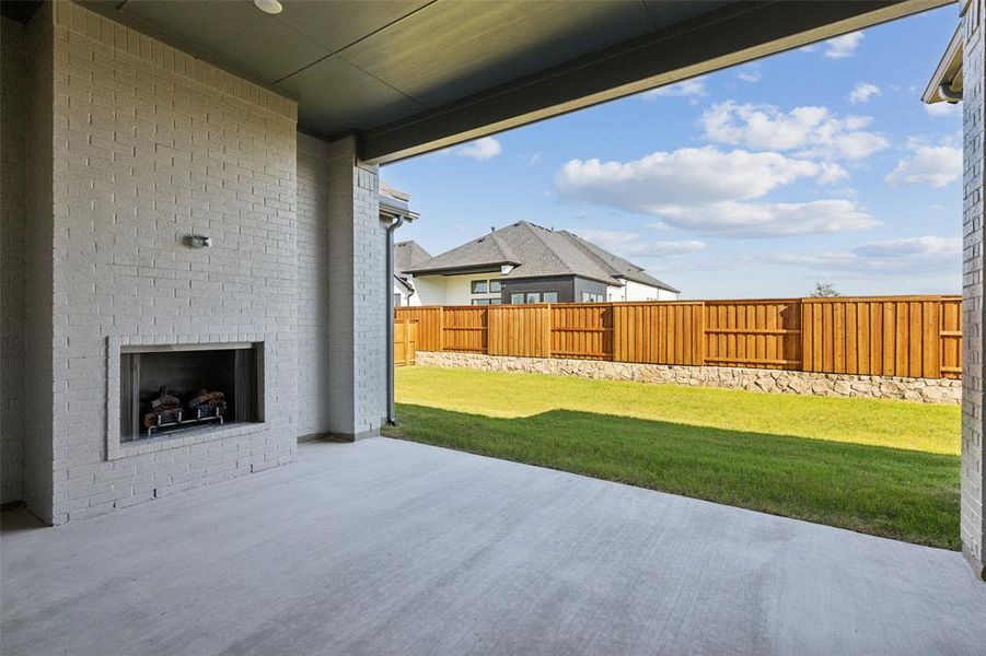 This outstanding covered back patio features a fireplace for you to enjoy those chilly fall Texas nights!