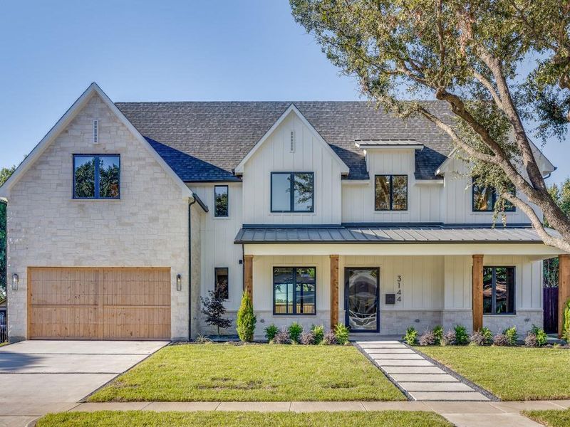 Modern farmhouse style home featuring covered porch, a garage, and a front lawn