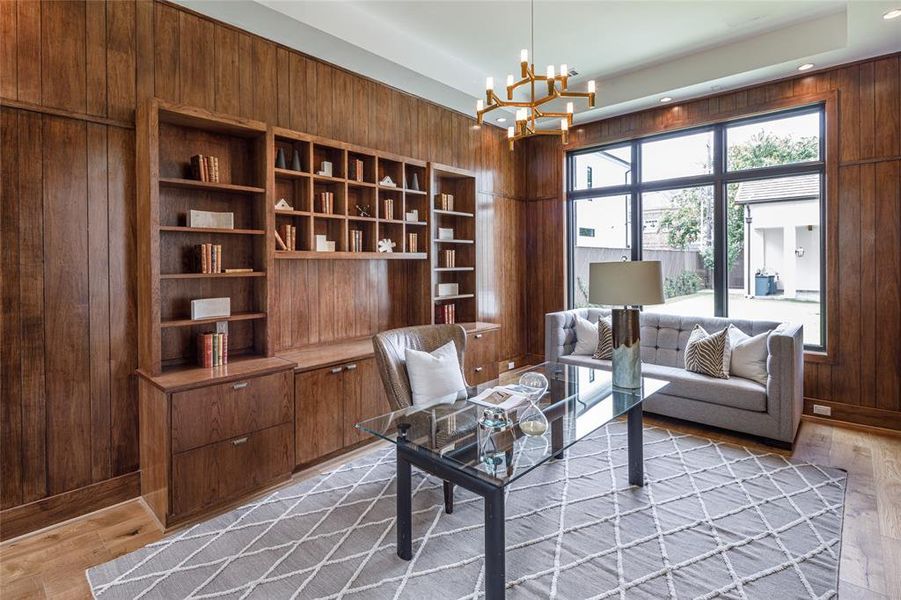 Custom built-in book shelves, printing press cabinetry hardware and picturesque windows with back yard views
