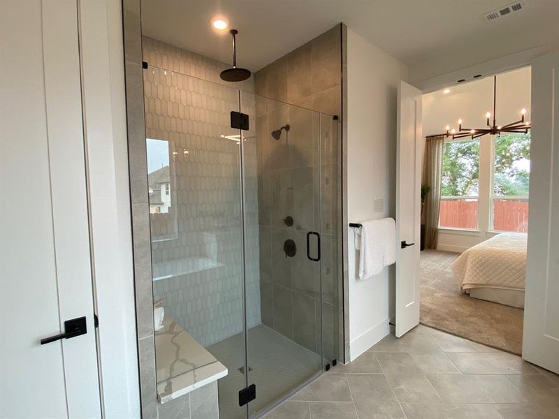 Separate mudset shower with seat, tile to ceiling, and additional rain shower head