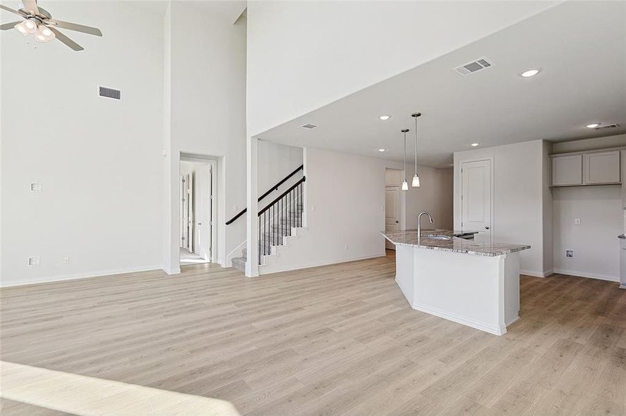 Unfurnished bedroom with light colored carpet and ceiling fan