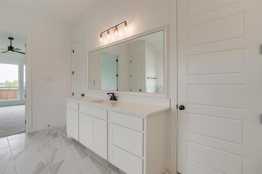 Bathroom featuring ceiling fan and vanity