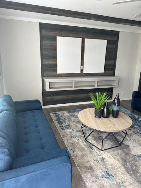 Living room with hardwood / wood-style flooring and ornamental molding