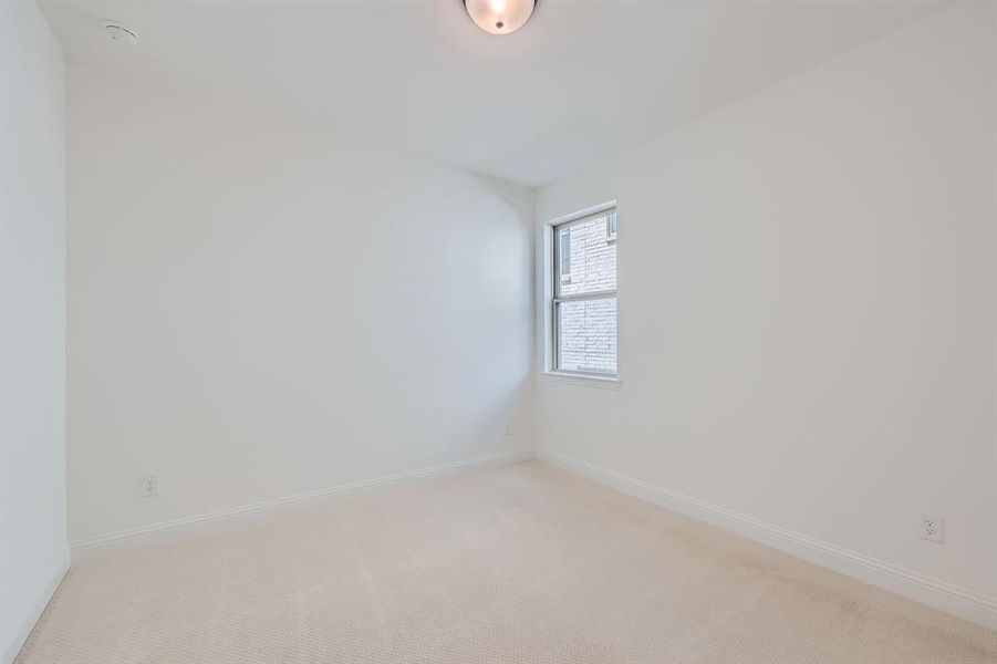 Unfurnished room featuring light colored carpet