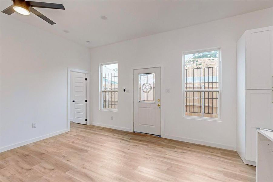 Entryway with light wood-type flooring and ceiling fan