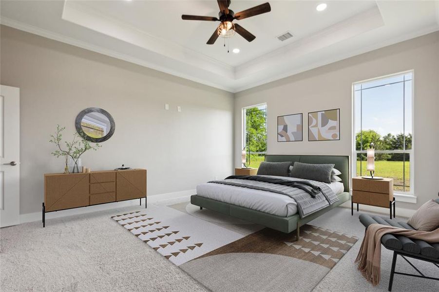 Carpeted bedroom with a tray ceiling, crown molding, and ceiling fan