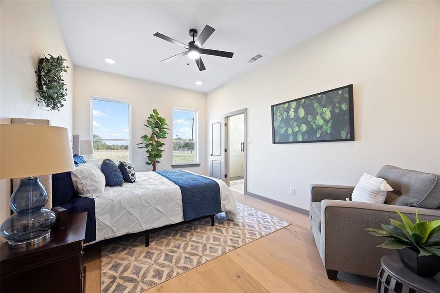 Bedroom featuring ceiling fan, ensuite bathroom, and light hardwood / wood-style floors