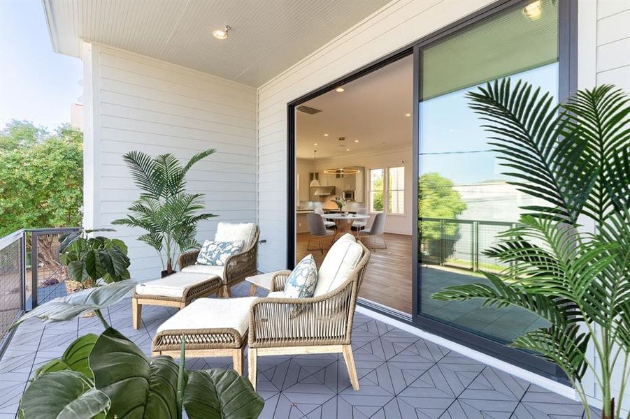 Bring the outdoors in with this spacious balcony featuring retractable glass sliders.