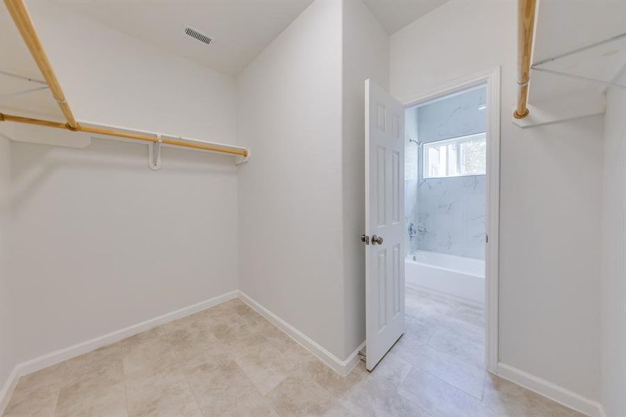 A major bonus of the primary bathroom is the impressive walk-in closet, offering ample space for all your wardrobe essentials. This thoughtfully designed area provides organized storage options, allowing you to keep your clothes and accessories neatly arranged and easily accessible. The walk-in closet adds a touch of luxury and convenience, making the primary suite even more desirable.