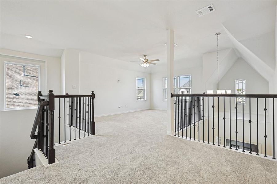 Hall featuring lofted ceiling and light carpet