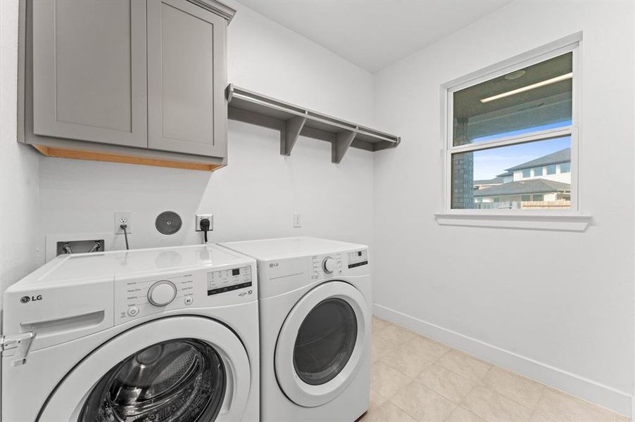 The laundry room is efficiently designed for convenience, featuring ample storage space and modern appliances to streamline chores.