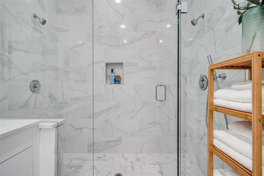 Bathroom with a shower with shower door and vanity