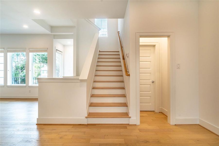 Stairs going to the third floor and the half bath