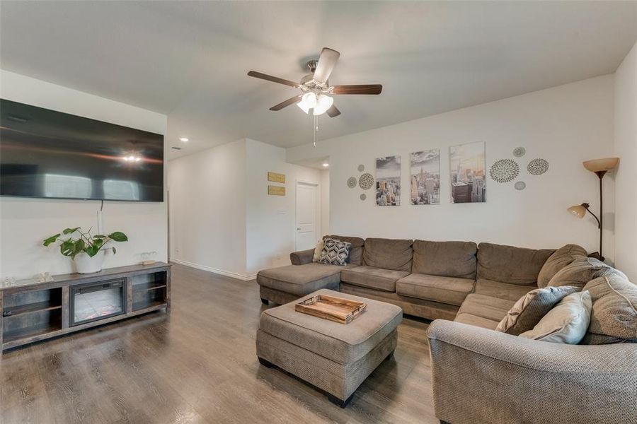 Living room with hardwood / wood-style floors and ceiling fan