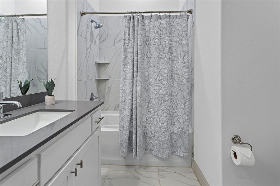 Bathroom featuring vanity and shower / tub combo