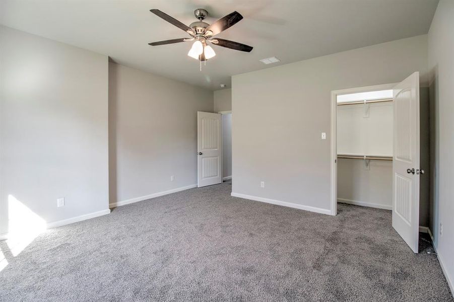 Unfurnished bedroom featuring a closet, carpet, and ceiling fan